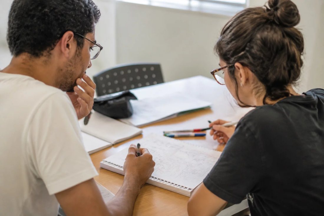 Estudantes de mochila conversando no corredor de uma universidade